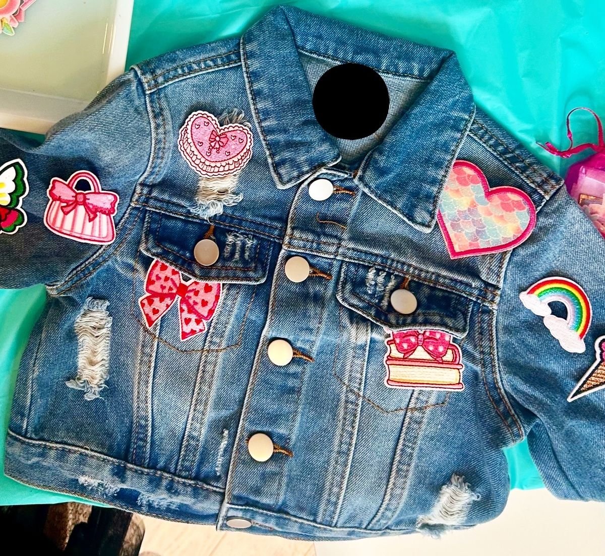 A denim jacket decorated with fabric patches at the Patch Station