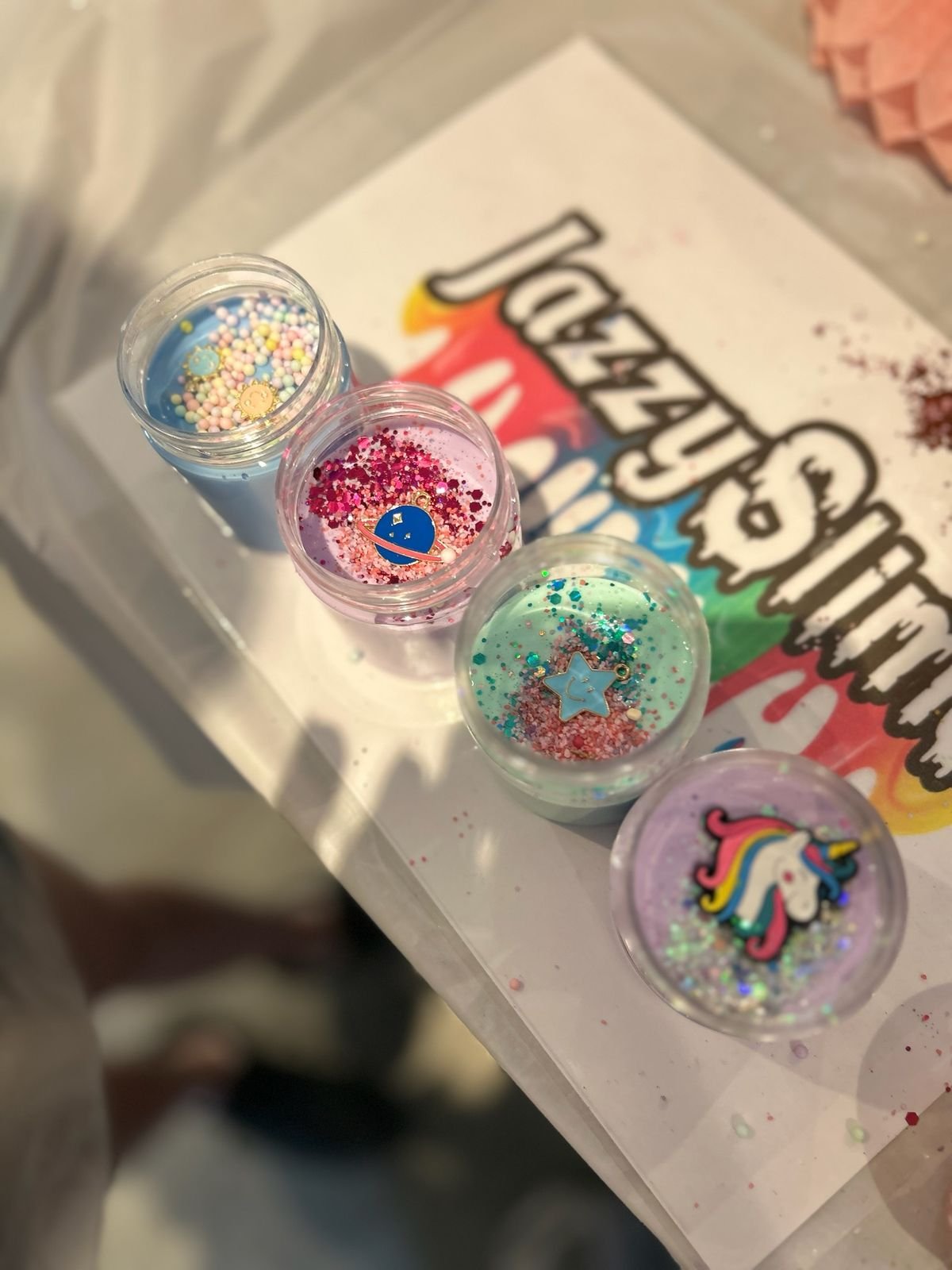 A Jazzy Slime branded bag with mini glitter pots