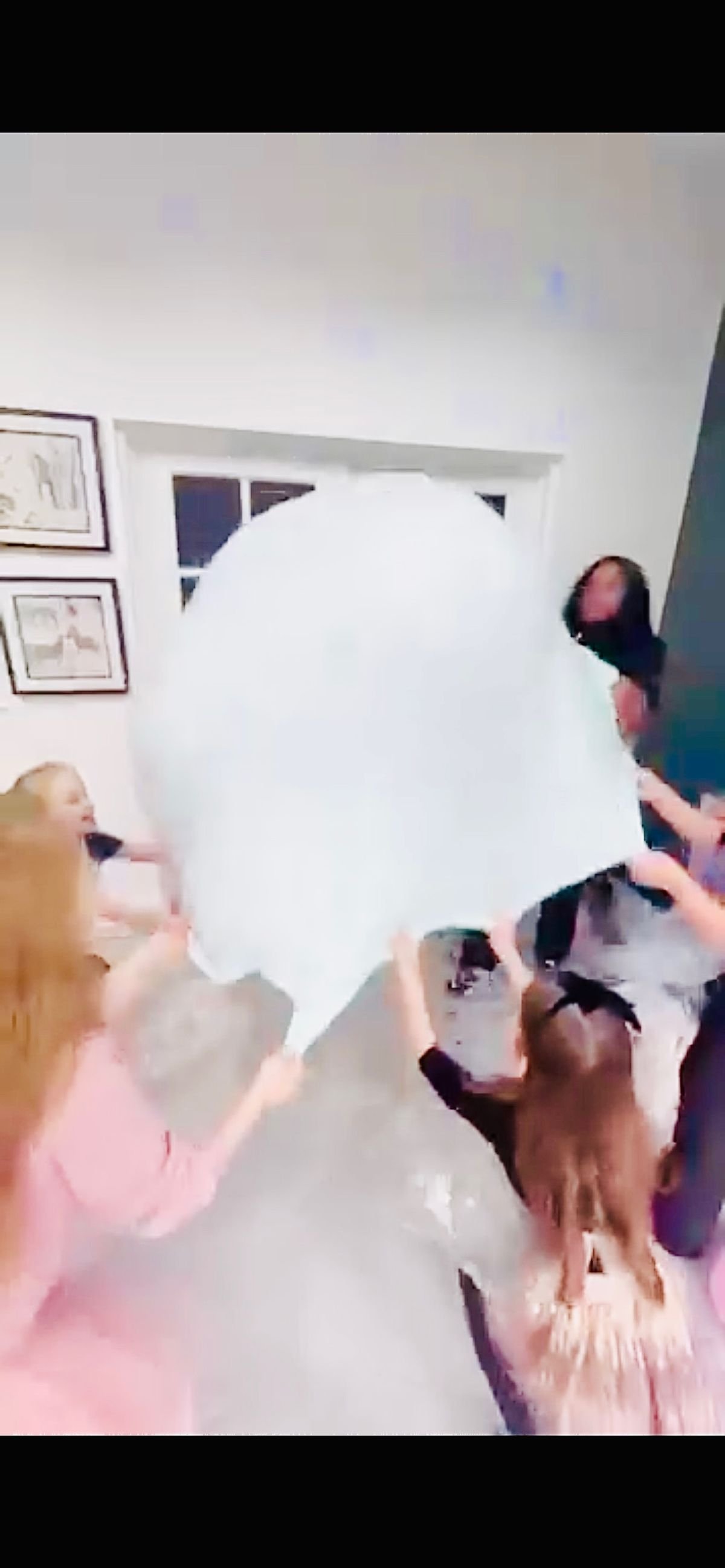 A child stretching a huge sheet of slime at a Jazzy Slime party