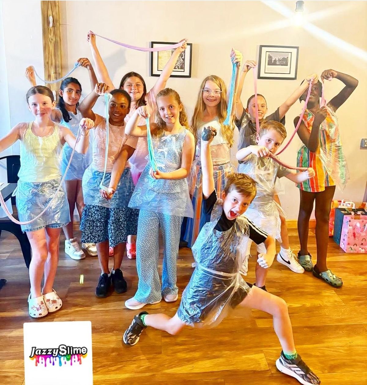 A group of children celebrating together at a Jazzy Slime party